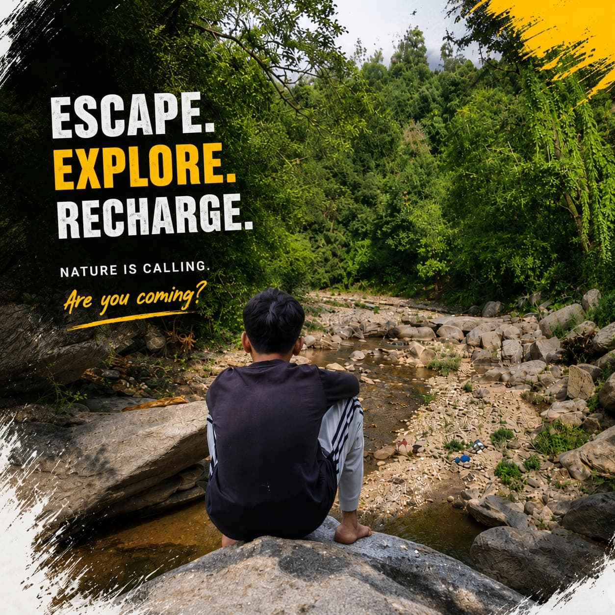 Boy sitting by a rocky mountain river